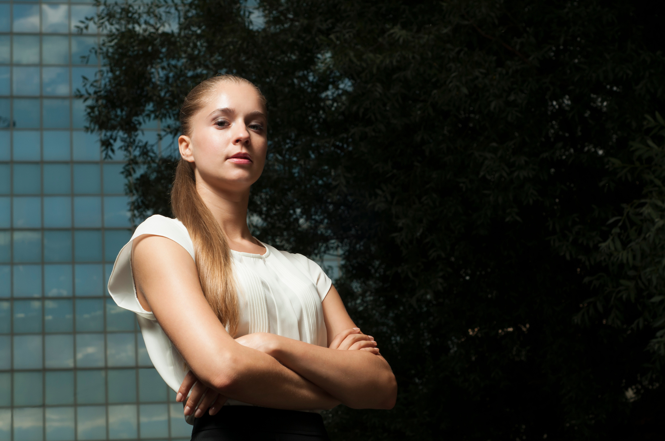 Female against mirror office building